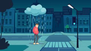 街中で雨に降られる男性